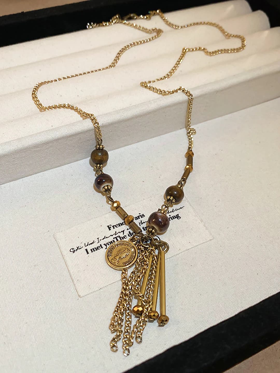 #57, gold, tassel
