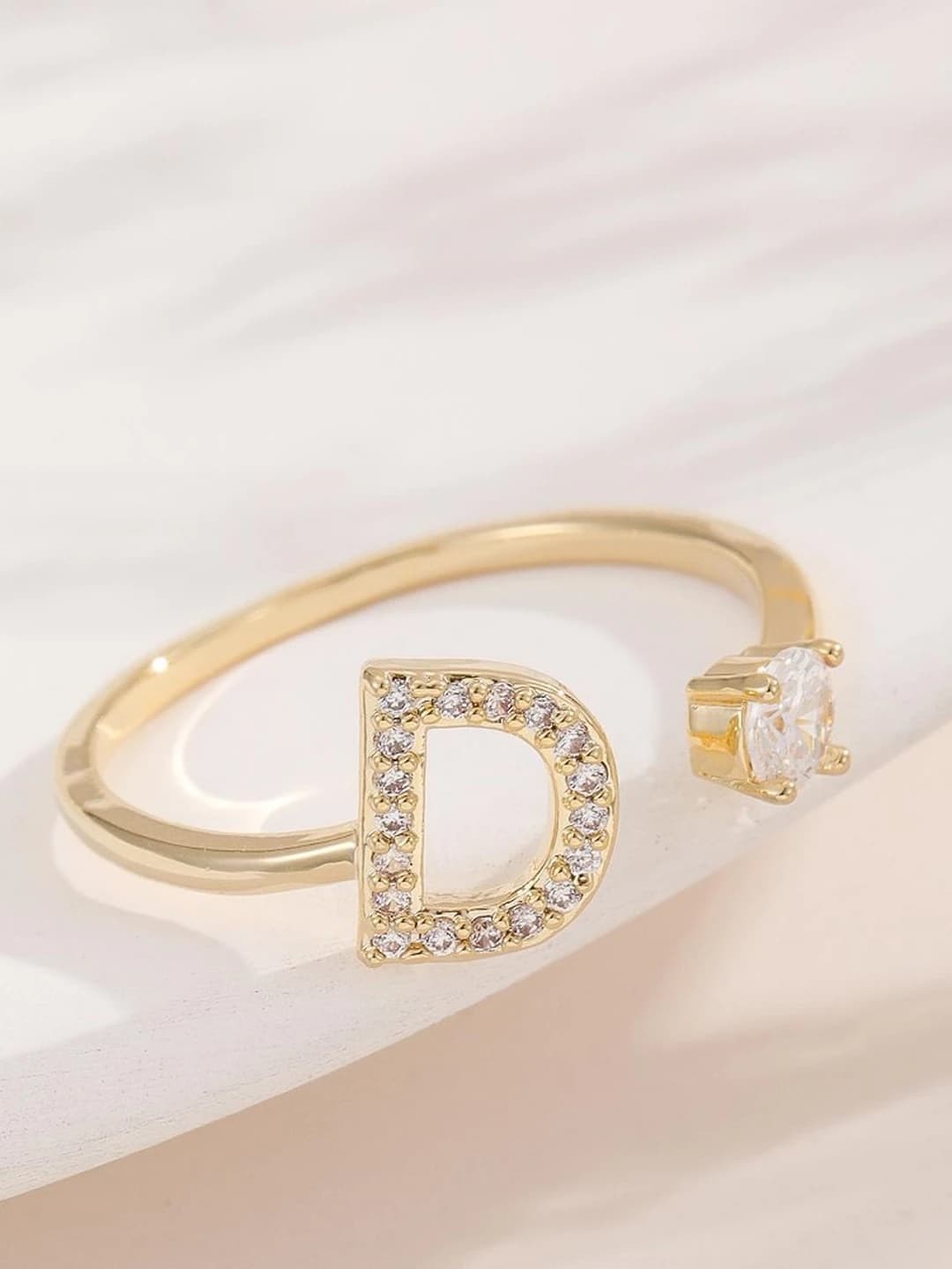 Gold letter D