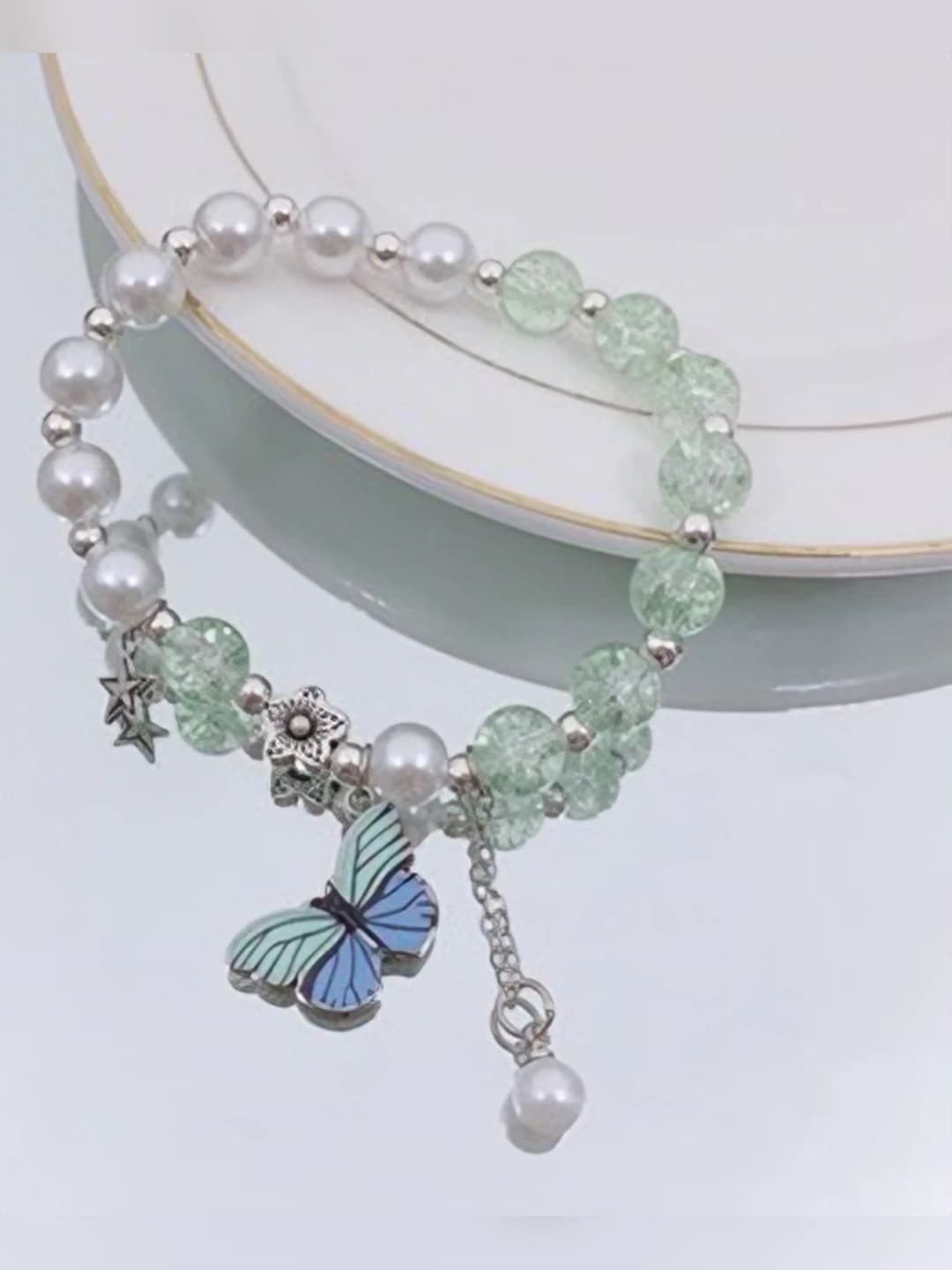 Blue-green butterfly pearl