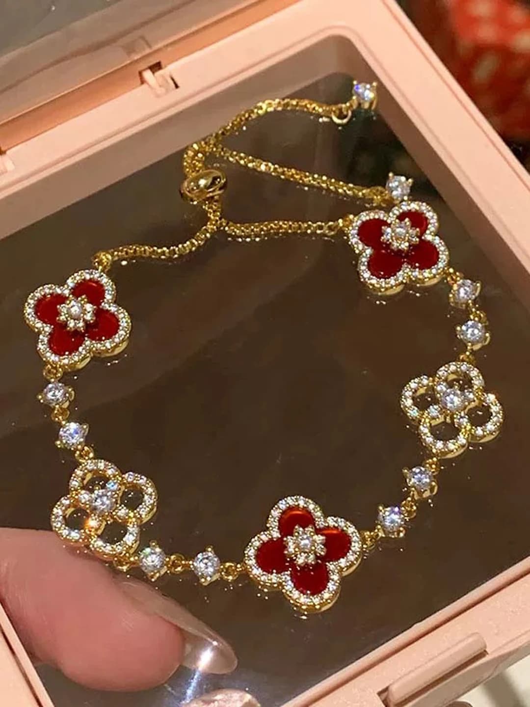 Gold bracelet with red flowers
