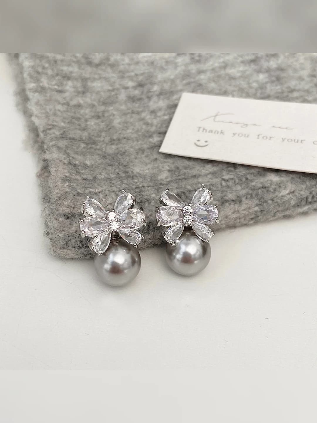 Silver bow zircon ear studs