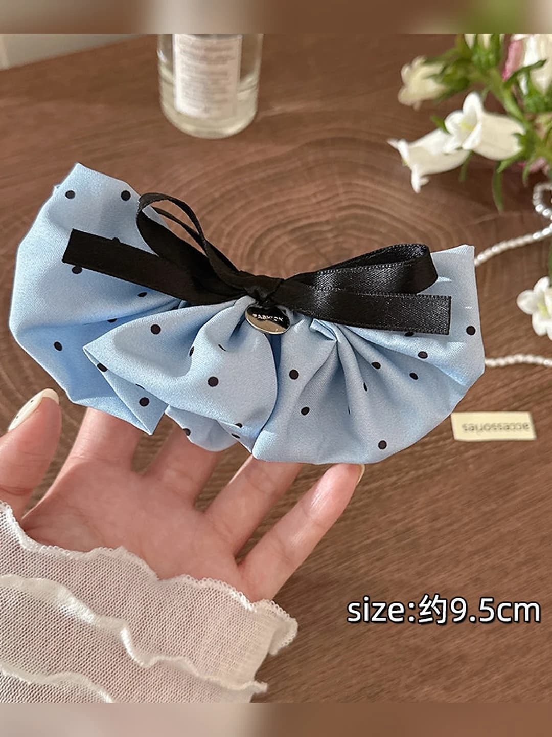 Blue polka dot banana clip, base ~10 cm
