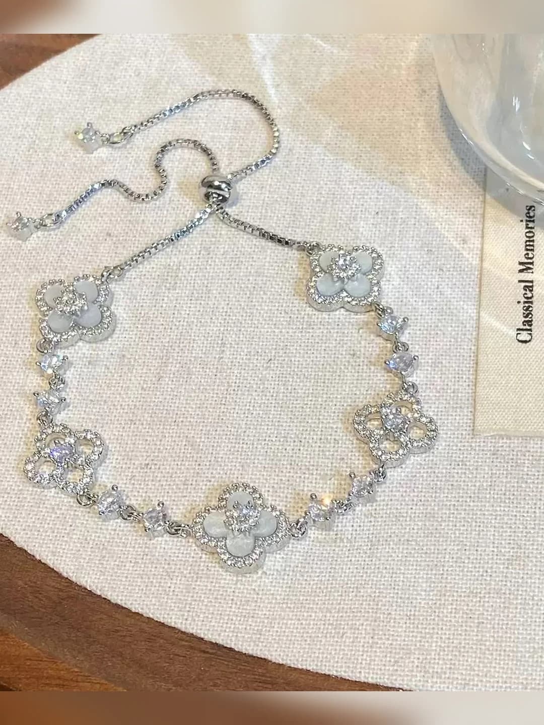 Silver bracelet with white flowers