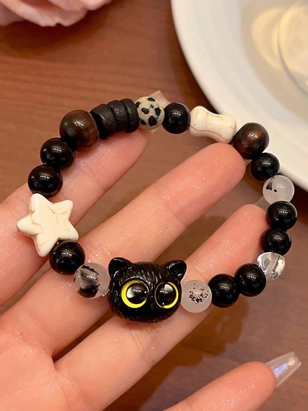 Black sesame kitten bracelet, yellow eyes