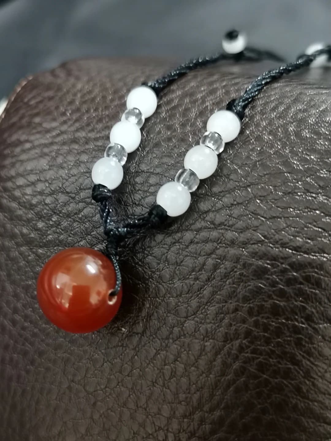 Black cord, red agate