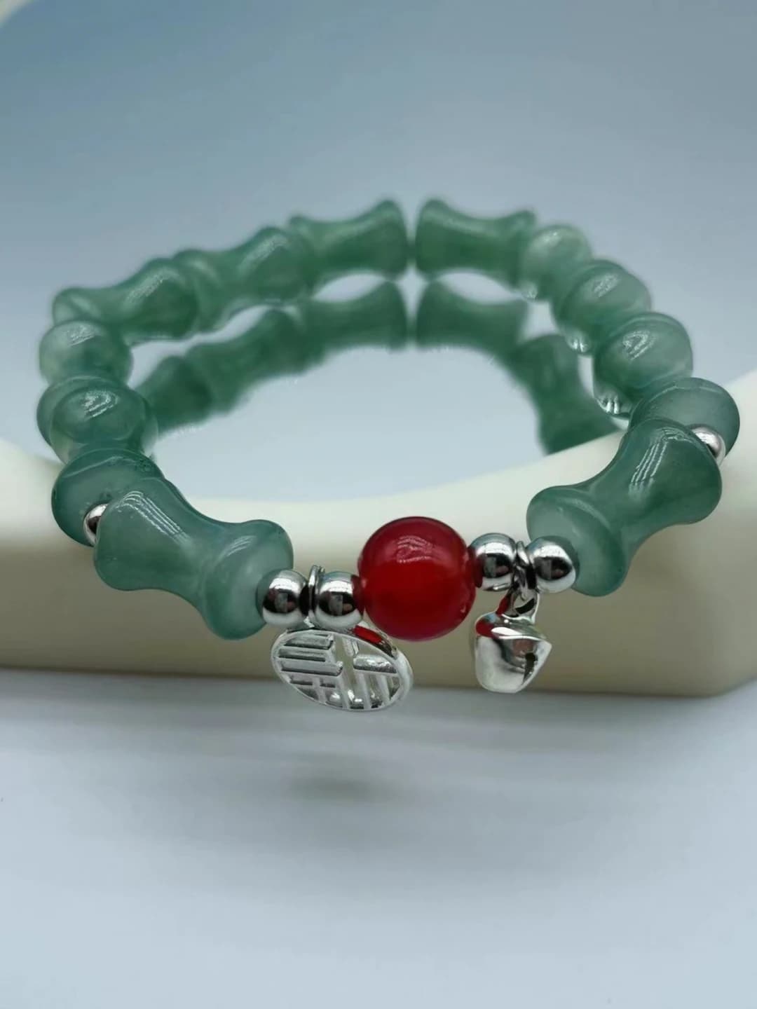 Green bamboo fu red bead bracelet