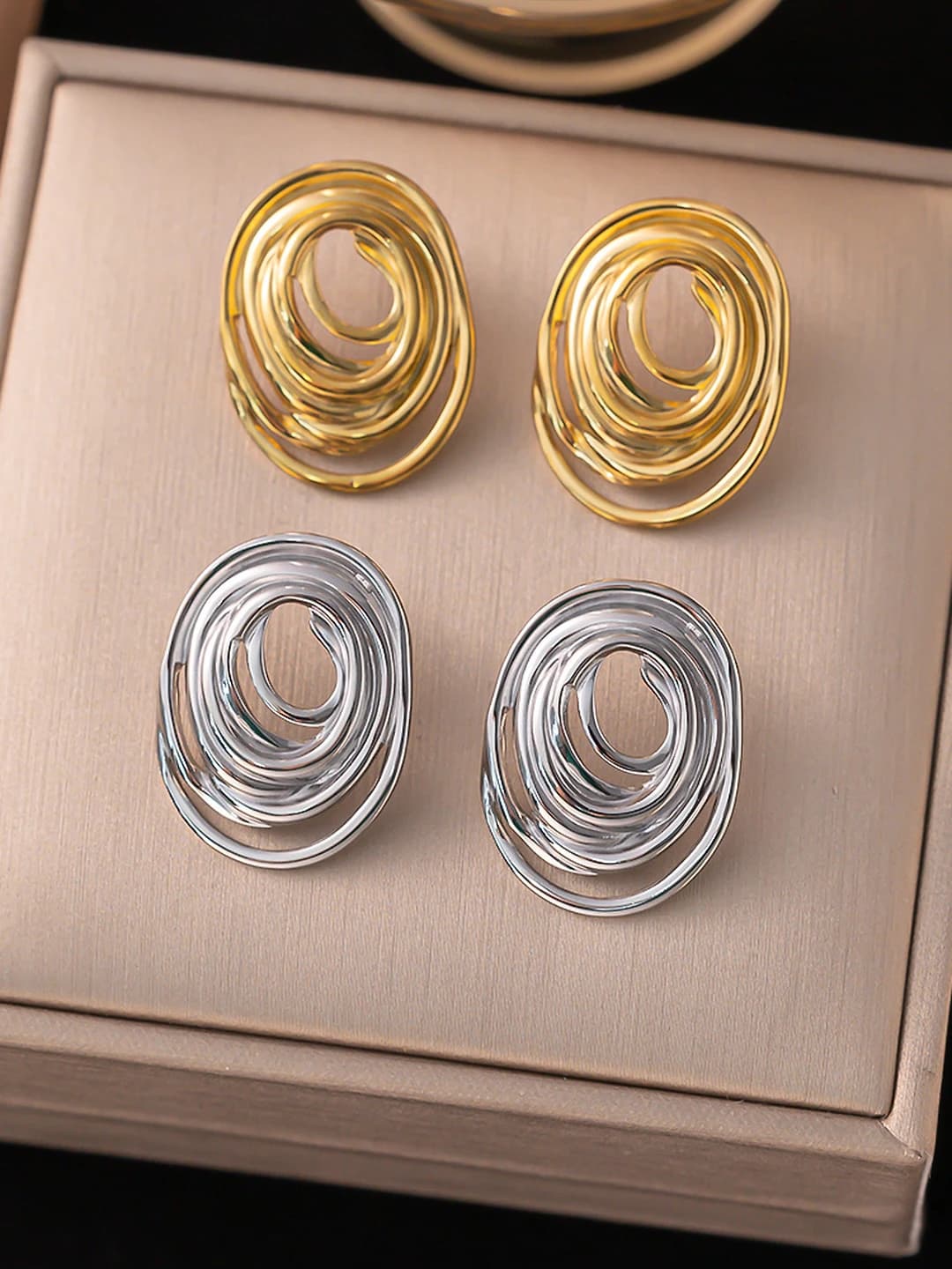 Women's titanium steel stud earrings with geometric oval design