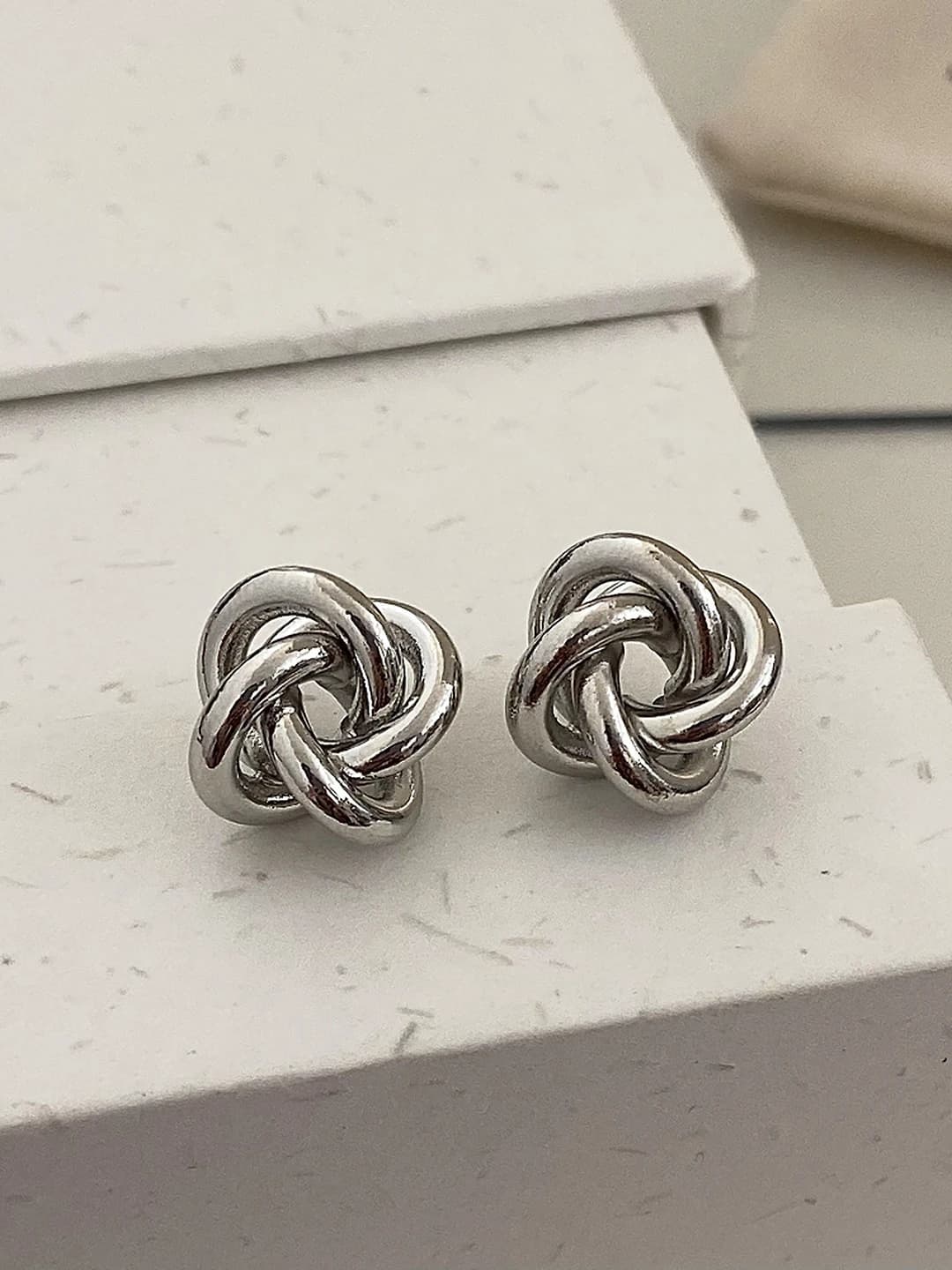 Silver intricate design studs