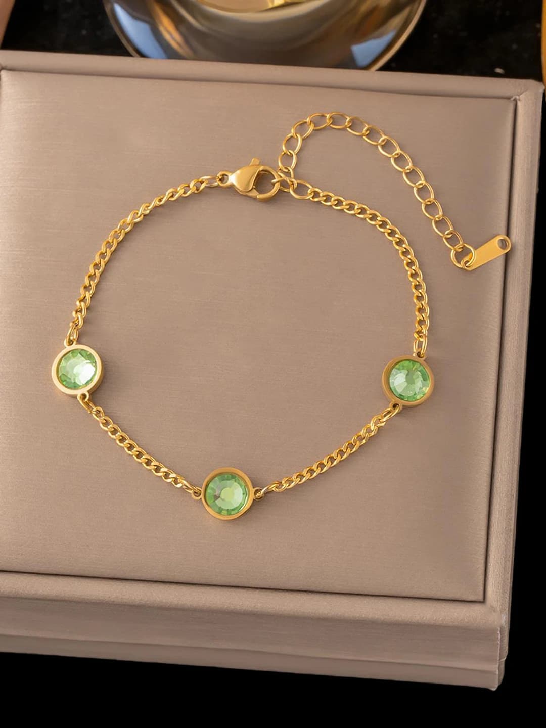 Three green diamonds, gold