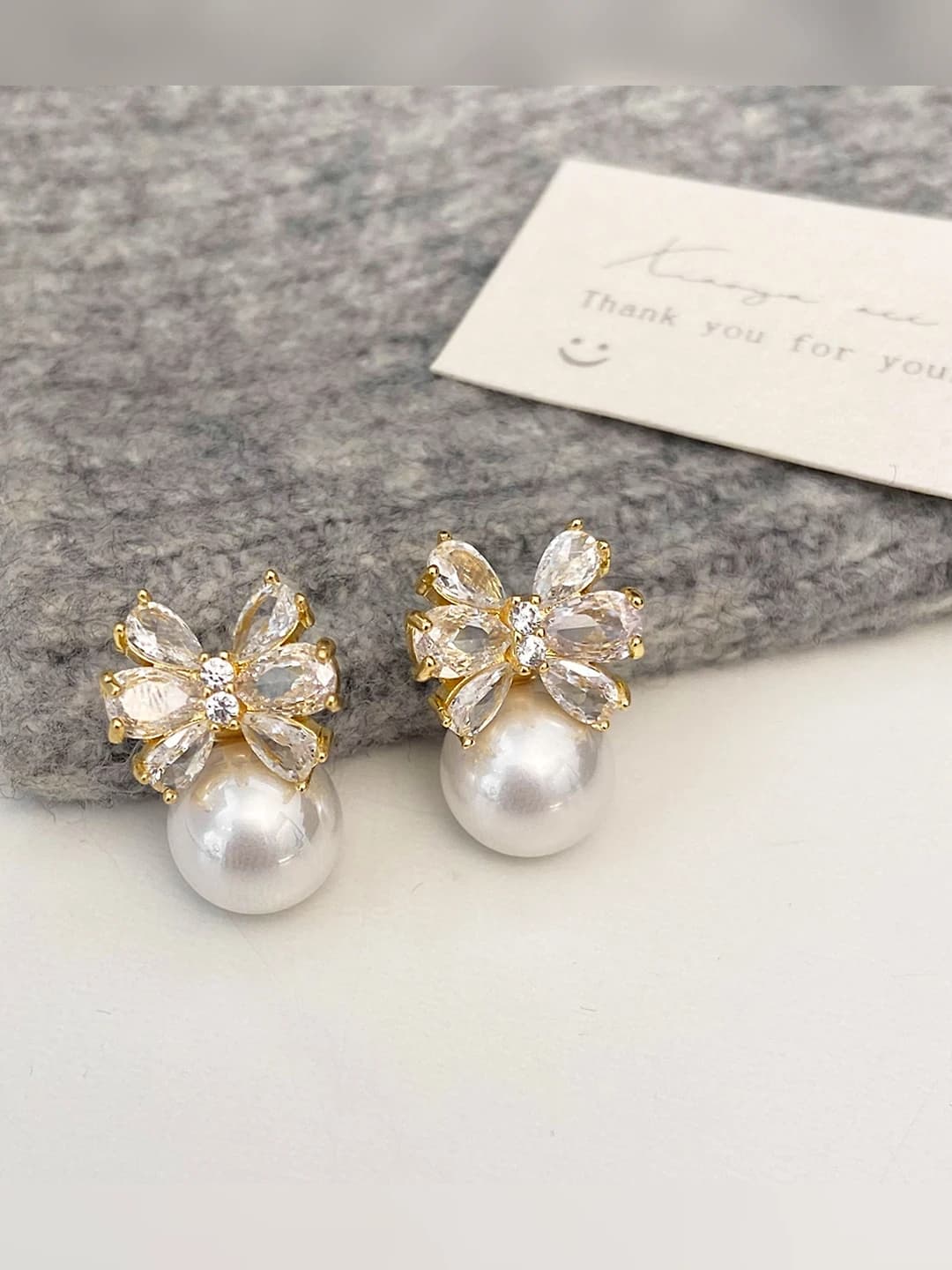 Gold bow zircon ear studs