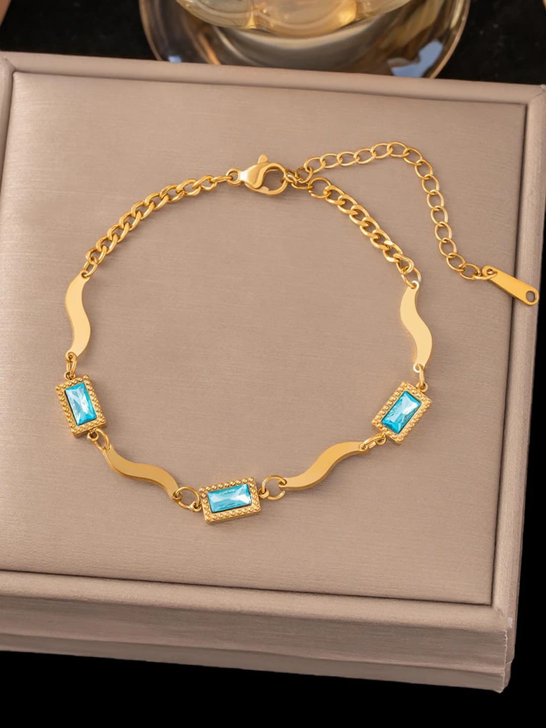 Three blue square diamonds, gold