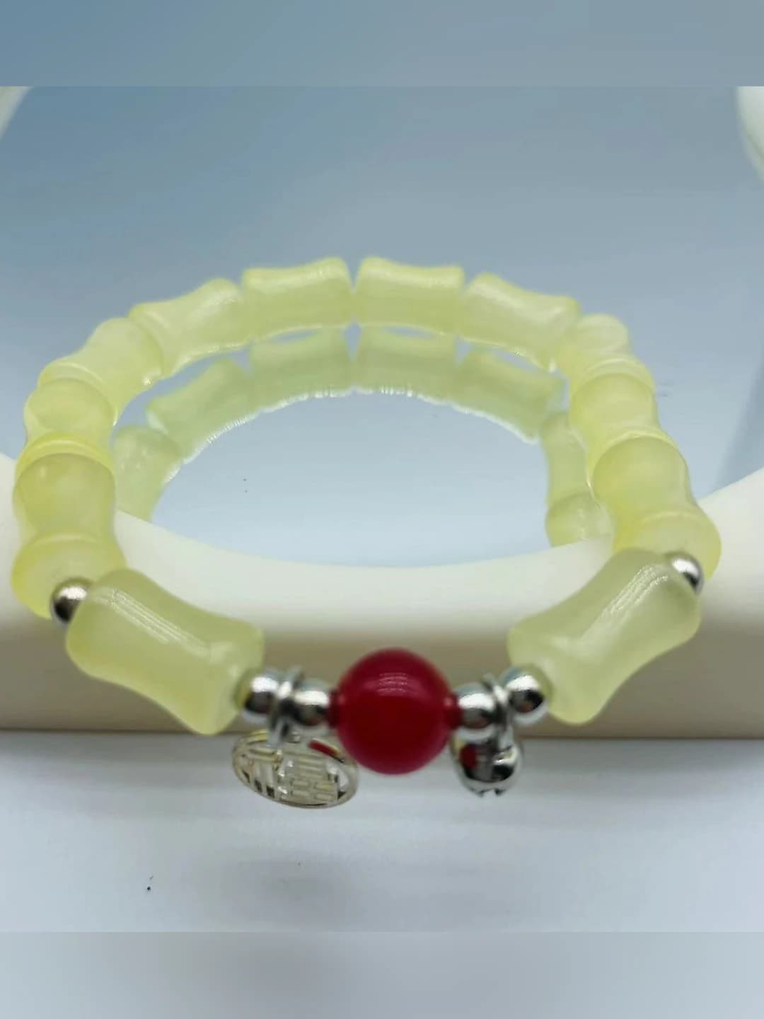 Yellow bamboo fu red bead bracelet