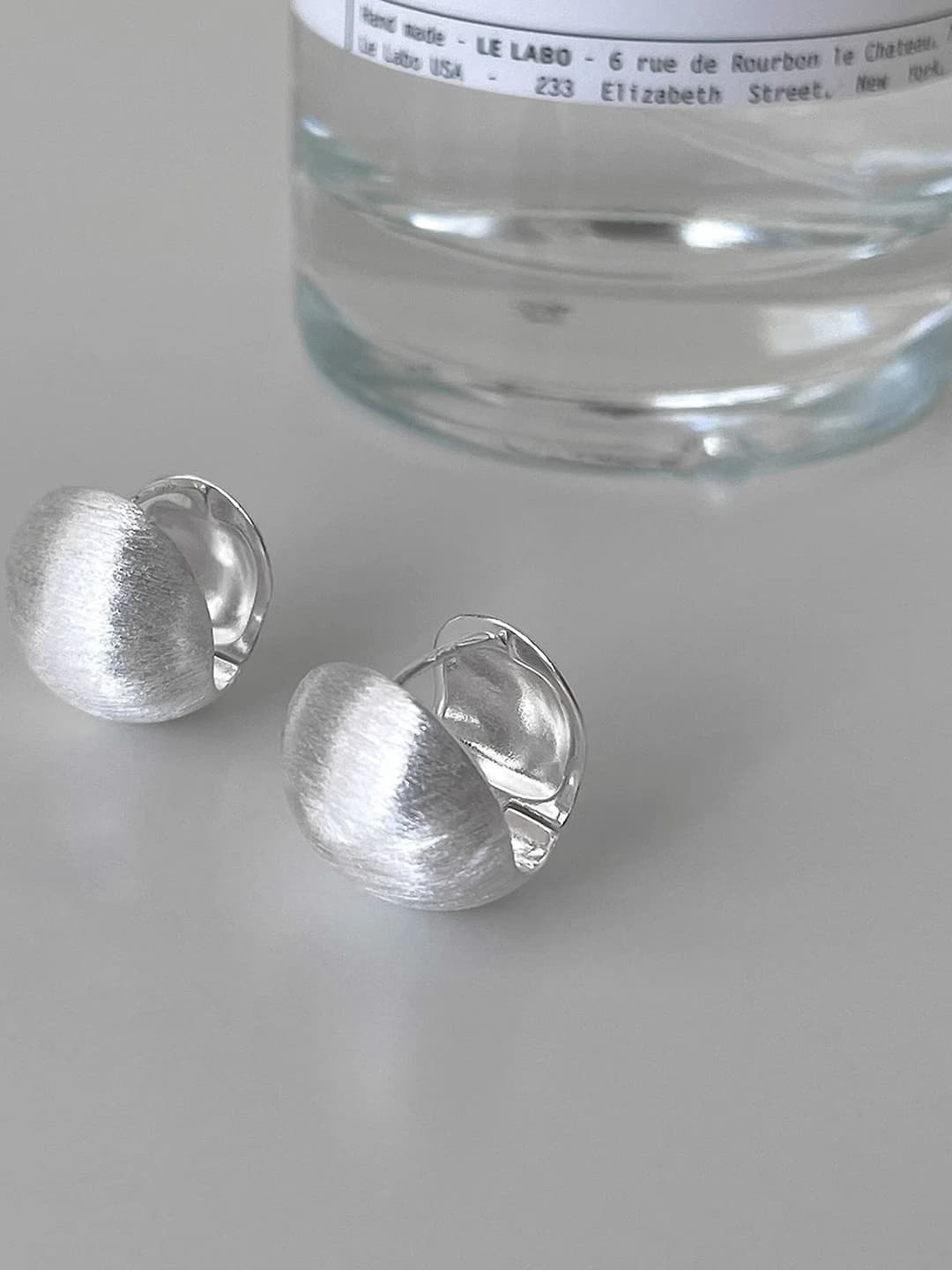 Women's matte metal half-circle earrings with geometric design