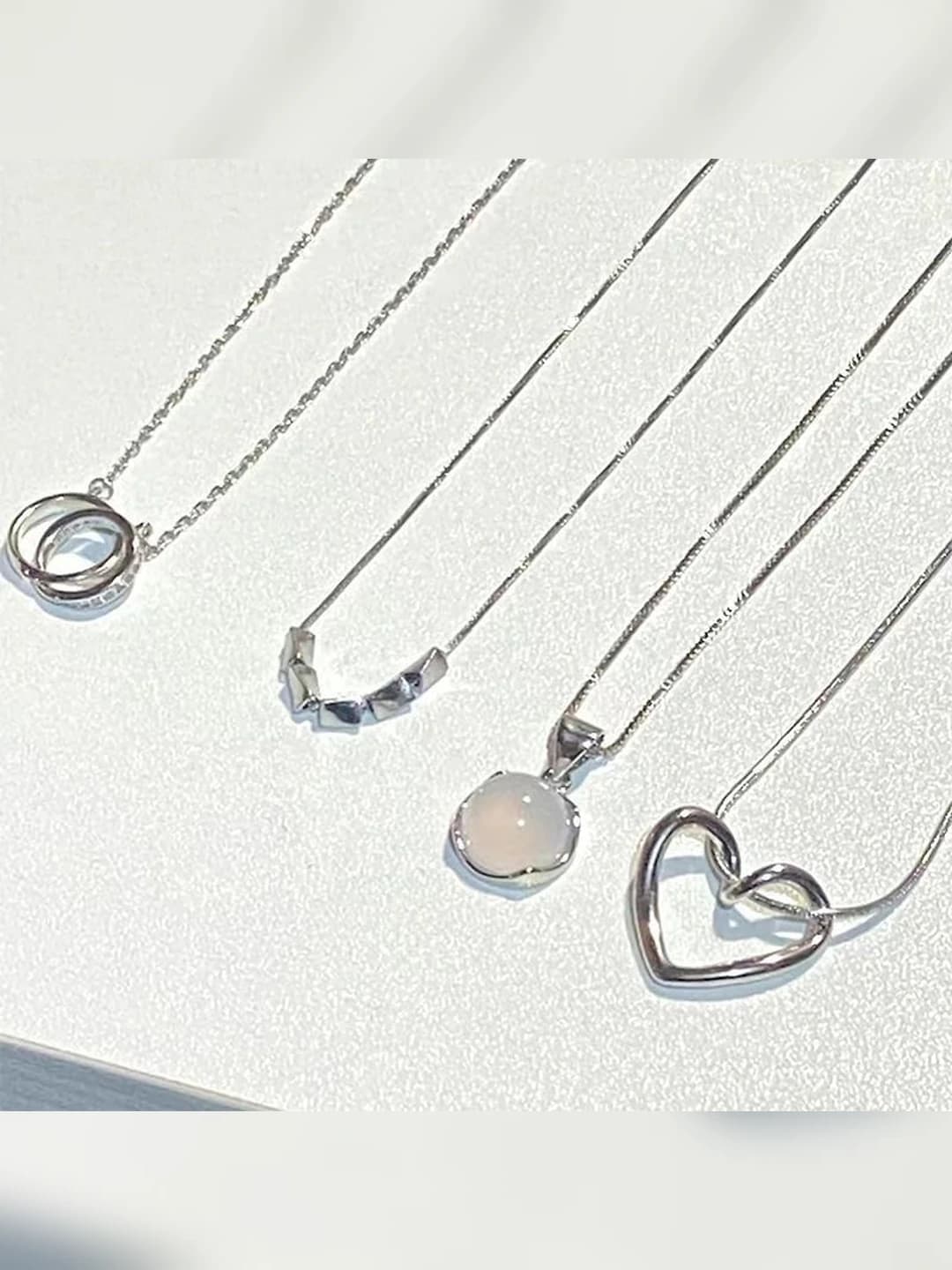 Silver heart pendant necklace for women, geometric design element, Chanel style chain