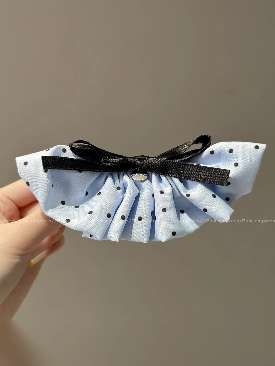 Blue polka dot banana clip, base ~10 cm