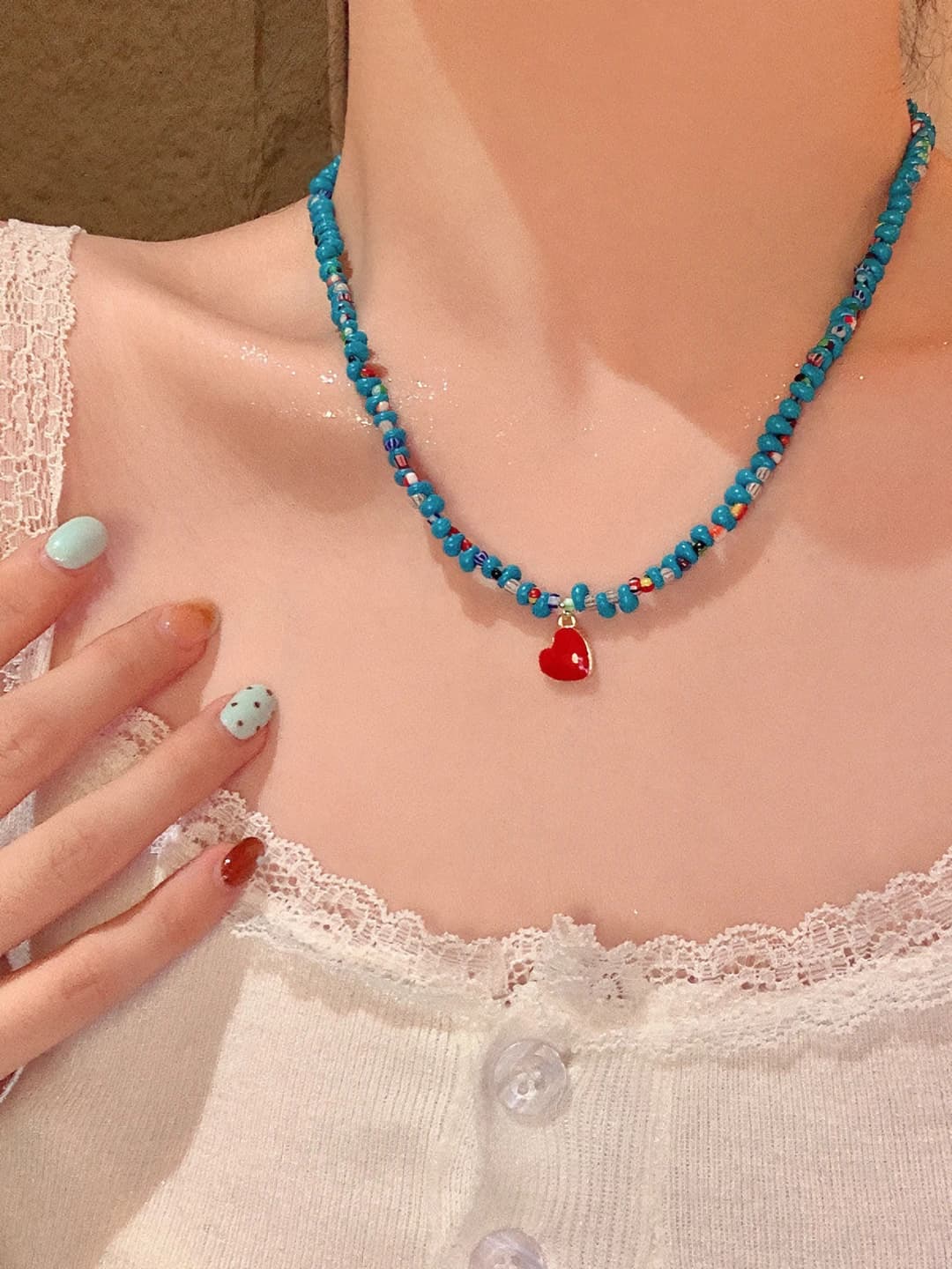 Women's short necklace with colorful glass beads and heart-shaped pendant