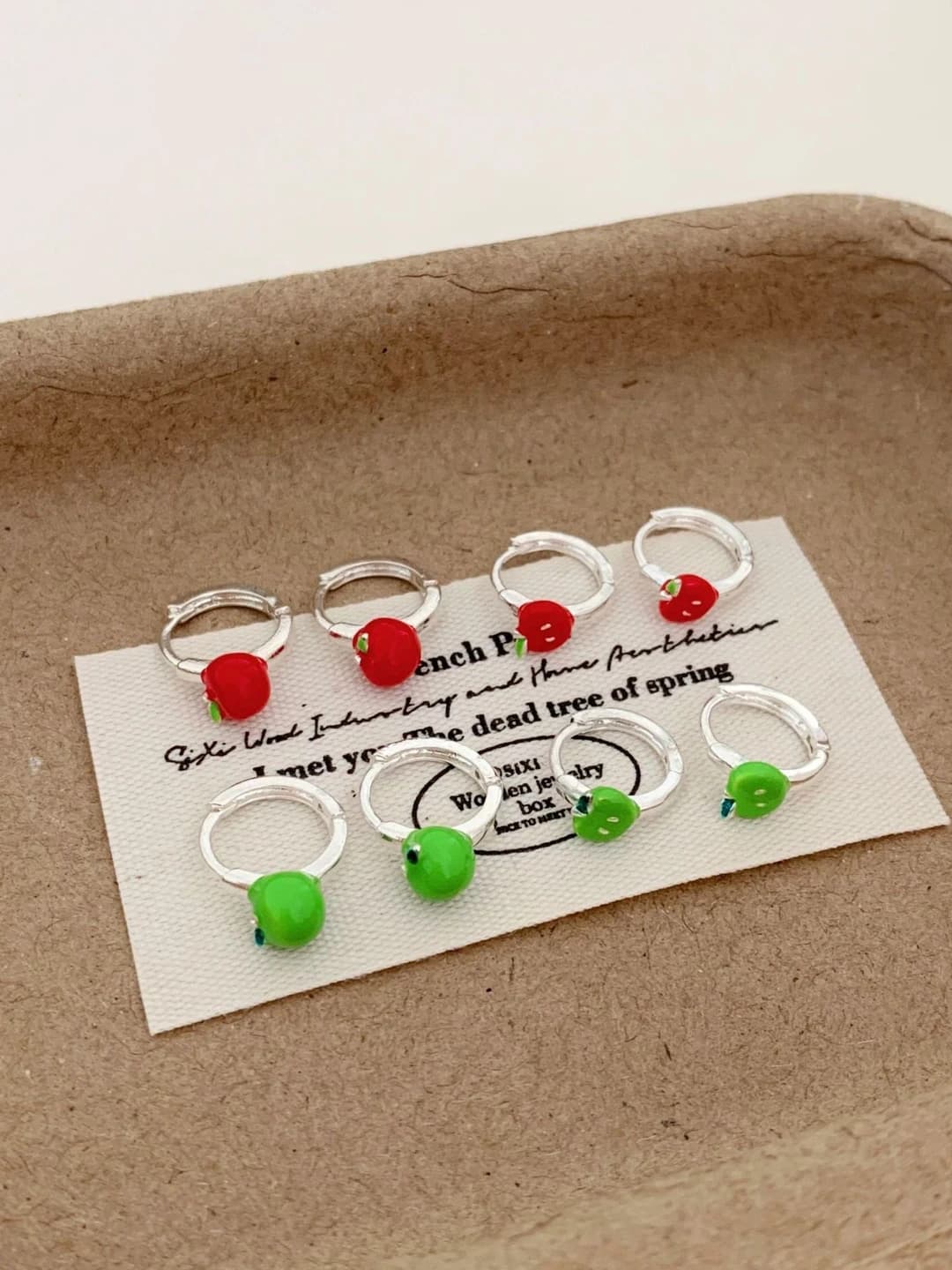 Women's apple-shaped copper ear studs with enamel, design element in sweet cool style